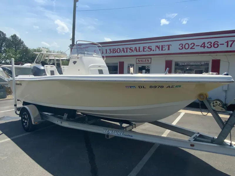 Slide: The Image of 2014 Tidewater 196 CC Adventure boat on a Venture trailer at a dealership. - 2