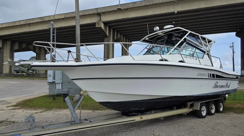 Slide: The Image of 1992 Stamas 288 Liberty boat on a trailer under a bridge. - 1