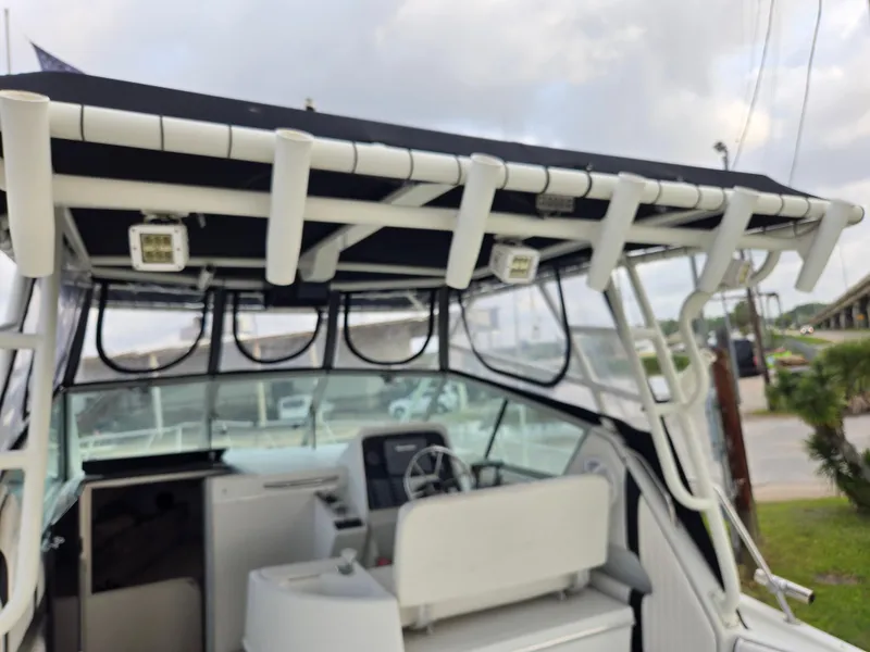 Slide: The Image of 1992 Stamas 288 Liberty boat interior with rod holders and steering console. - 11