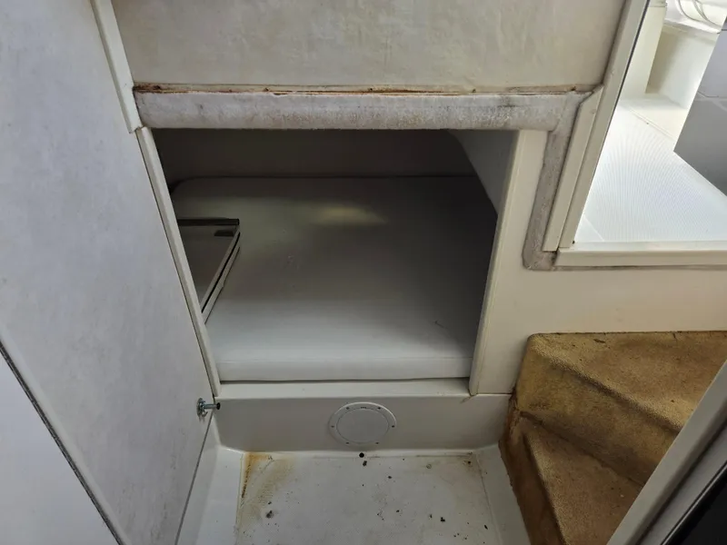 Slide: The Image of Interior cabin of a 1992 Stamas 288 Liberty boat, featuring a compact sleeping area. - 12