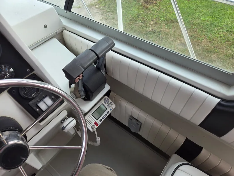 Slide: The Image of Interior view of 1992 Stamas 288 Liberty boat cockpit with steering wheel and controls. - 13