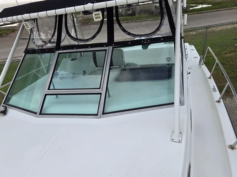 Slide: The Image of 1992 Stamas 288 Liberty boat with windshield and canopy, docked on a sunny day. - 21