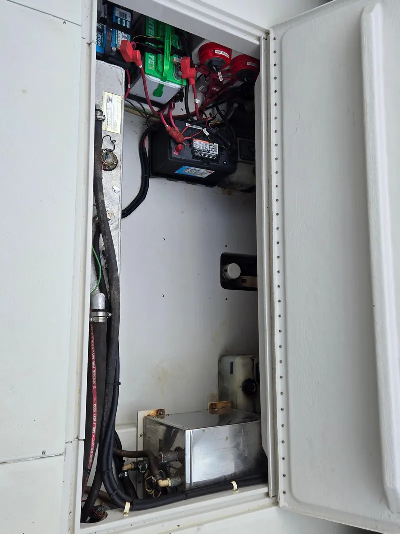 Slide: The Image of Electrical compartment of a 1992 Stamas 288 Liberty boat, showing batteries and wiring. - 25