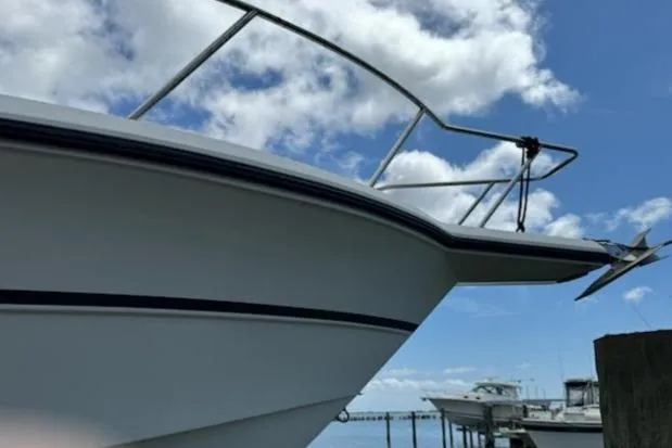 Slide: The Image of 1992 Stamas 288 Liberty boat docked under a blue sky with clouds. - 6