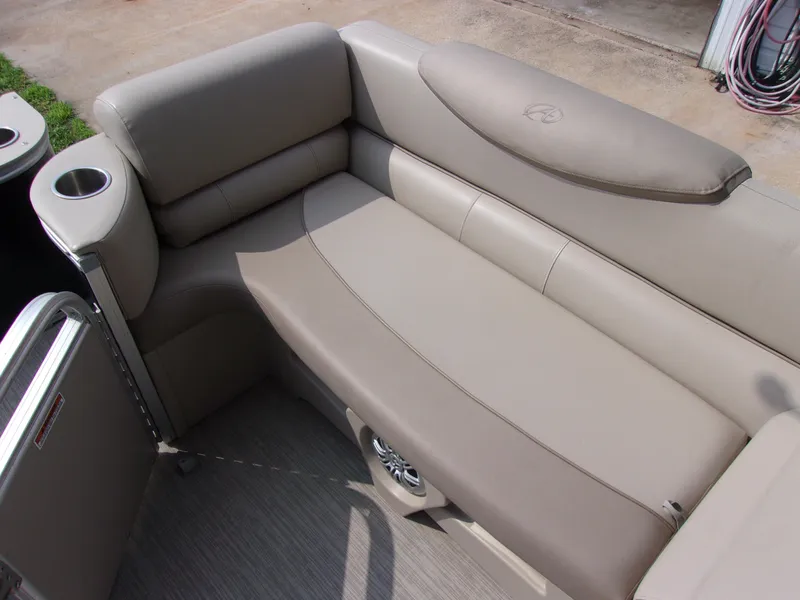 Slide: The Image of 2018 Avalon Catalina Cruise 23' boat interior with beige seating and cup holder. - 10