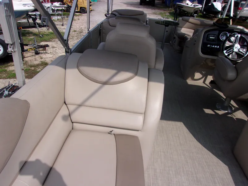 Slide: The Image of Interior of 2018 Avalon Catalina Cruise 23' pontoon boat with beige seating and steering console. - 11