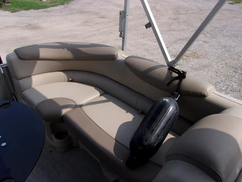 Slide: The Image of 2018 Avalon Catalina Cruise 23' boat interior with beige seating and black fender. - 13