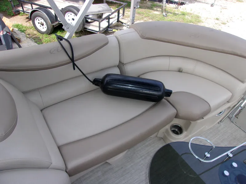 Slide: The Image of 2018 Avalon Catalina Cruise 23' boat with beige seating and black fender. - 14