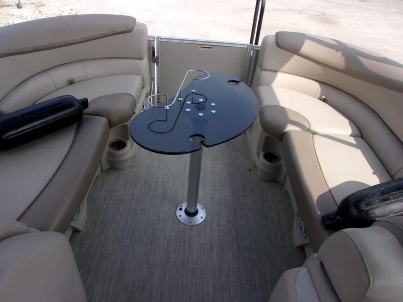 Slide: The Image of 2018 Avalon Catalina Cruise 23' interior with beige seating and a central table. - 15