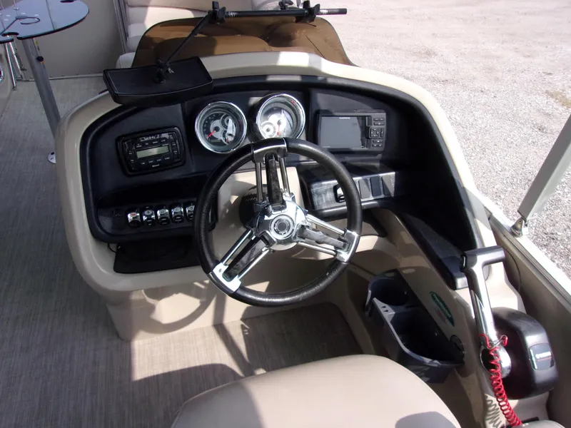 Slide: The Image of 2018 Avalon Catalina Cruise 23' boat dashboard with steering wheel and control panel. - 6