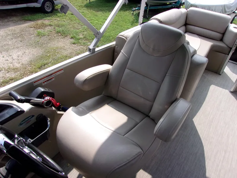 Slide: The Image of 2018 Avalon Catalina Cruise 23' boat interior with captain's chair and seating area. - 7