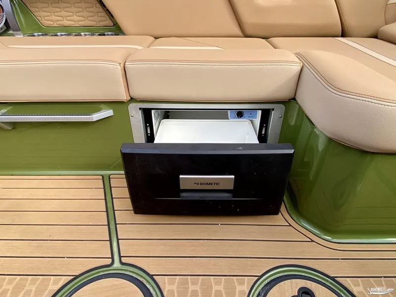 Slide: The Image of 2022 MasterCraft X26 boat with built-in Dometic refrigerator and tan seating. - 15