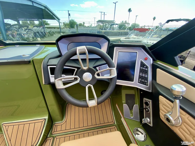 Slide: The Image of 2022 MasterCraft X26 boat cockpit with steering wheel and control panel. - 16