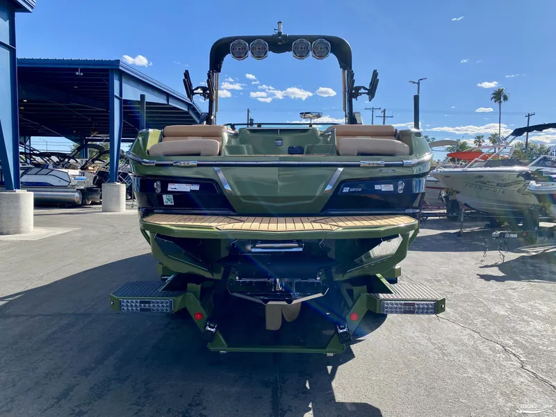 Slide: The Image of 2022 MasterCraft X26 boat rear view at marina. - 3