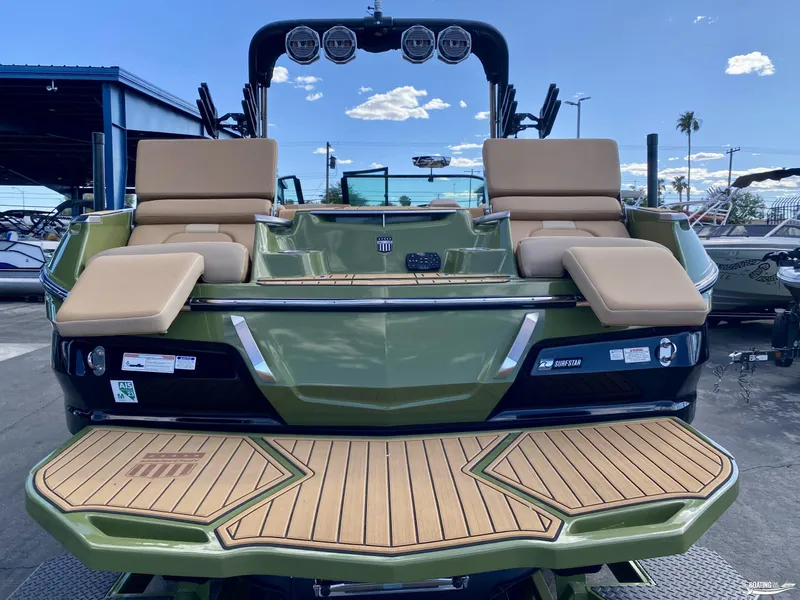 Slide: The Image of 2022 MasterCraft X26 boat with tan seats and green exterior. - 4