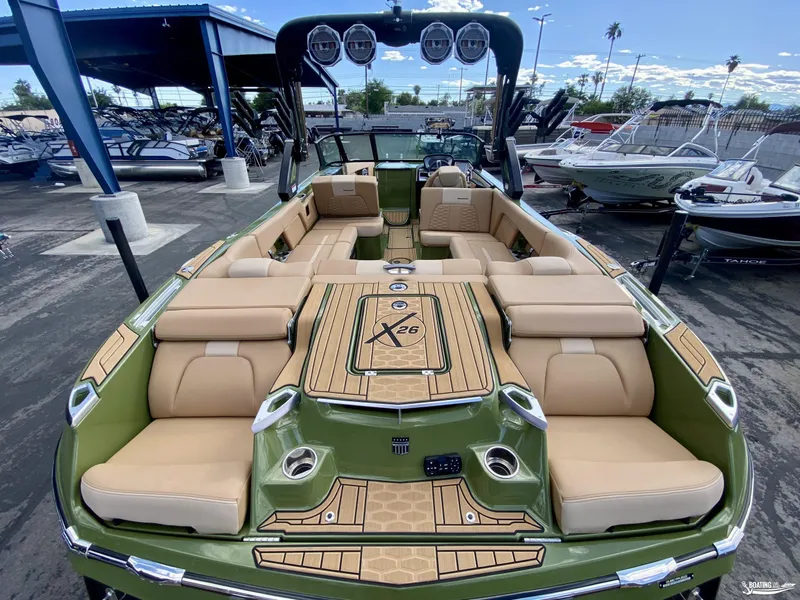 Slide: The Image of 2022 MasterCraft X26 boat with luxurious seating and modern design in a marina. - 6