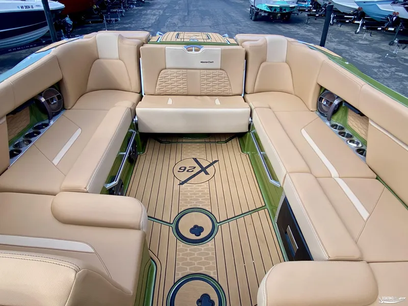 Slide: The Image of 2022 MasterCraft X26 boat interior with tan leather seating and custom flooring. - 8