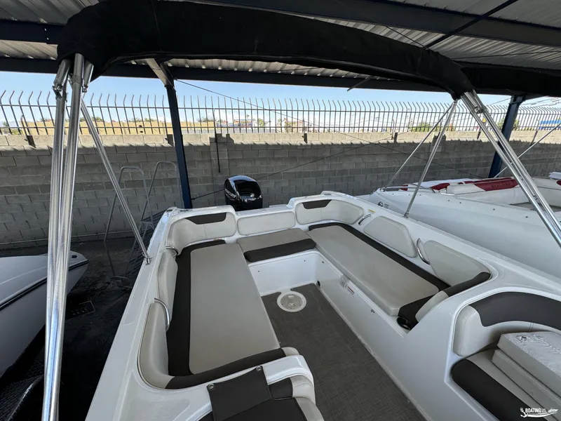 Slide: The Image of 2020 Bayliner E21 boat interior with spacious seating under a canopy. - 11