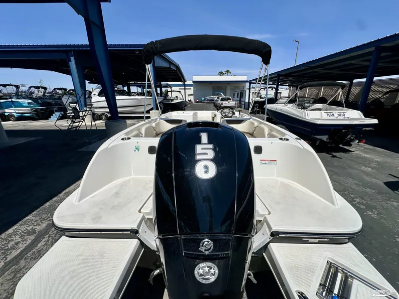 Slide: The Image of 2020 Bayliner E21 boat with 150 HP Mercury engine in a marina. - 3