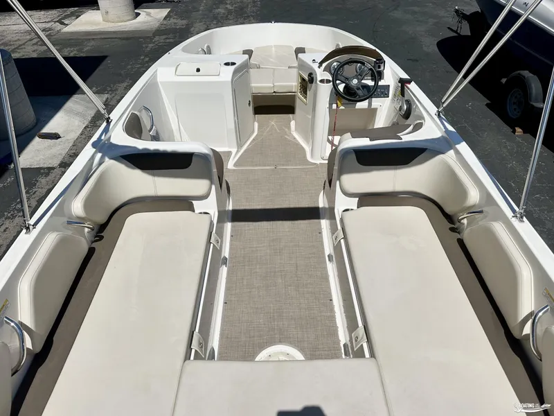 Slide: The Image of 2020 Bayliner E21 boat interior with spacious seating and steering console. - 5