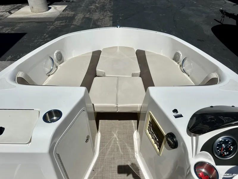 Slide: The Image of 2020 Bayliner E21 boat interior with beige seating and dashboard. - 6