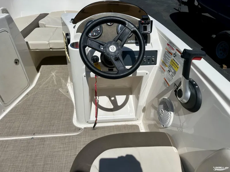 Slide: The Image of 2020 Bayliner E21 boat cockpit with steering wheel and throttle controls. - 7