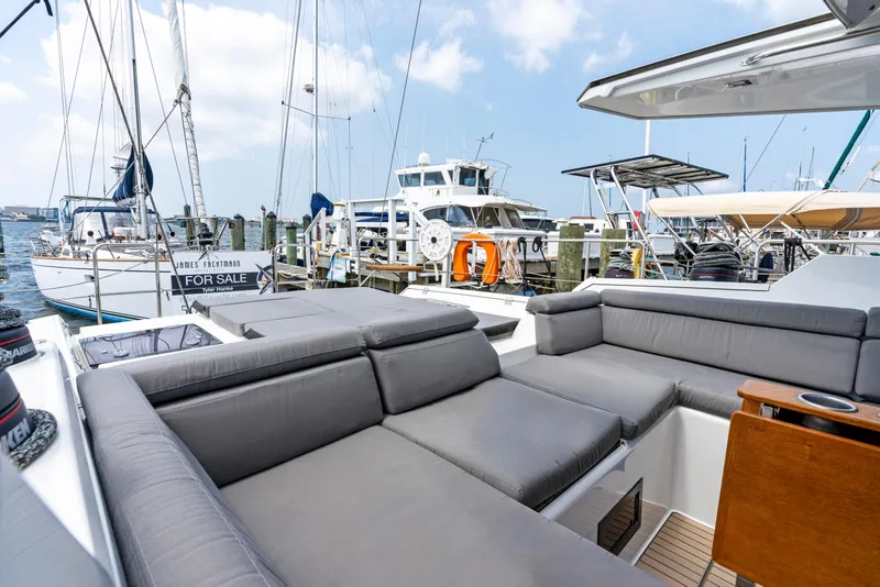 Slide: The Image of 2019 Amel 50 yacht with gray cushions docked at marina. - 25