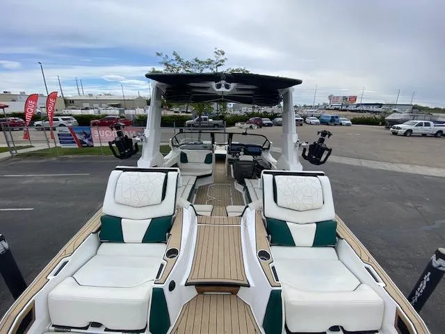 Slide: The Image of 2020 Nautique PARAGON 23 boat with luxurious seating and modern design in a parking lot. - 10