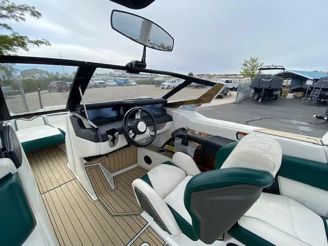 Slide: The Image of 2020 Nautique PARAGON 23 boat interior with luxurious seating and modern dashboard. - 11