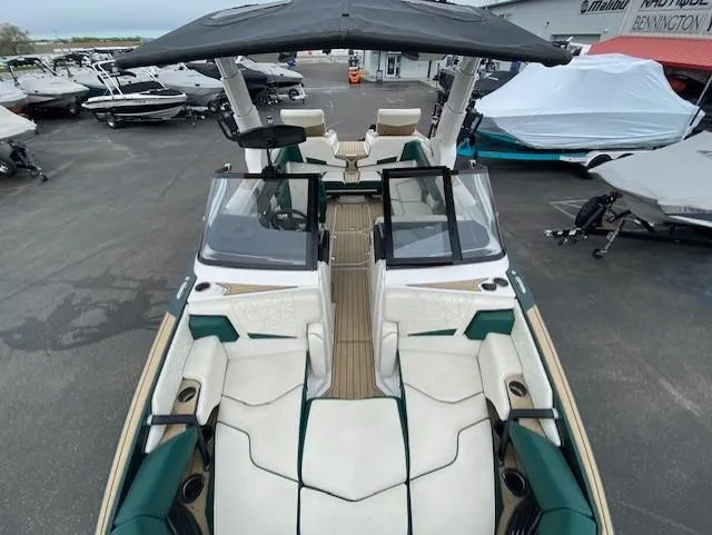 Slide: The Image of 2020 Nautique PARAGON 23 boat with open deck, docked among other boats. - 15