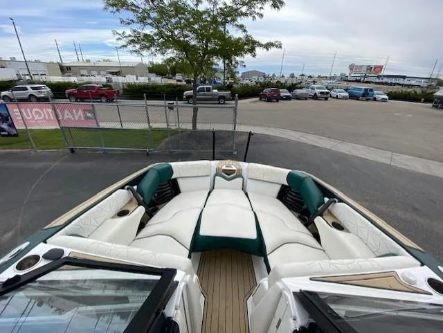 Slide: The Image of 2020 Nautique PARAGON 23 boat with luxurious seating, parked in a lot. - 16