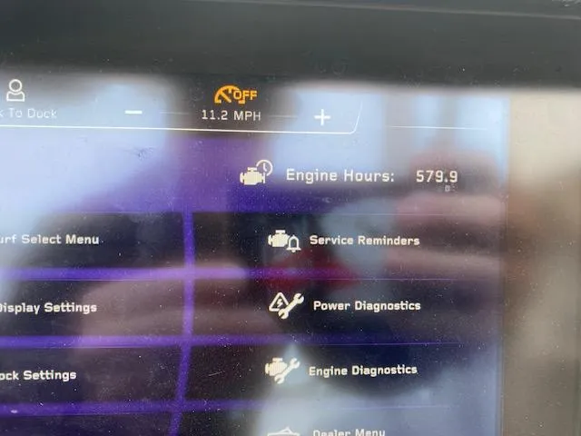 Slide: The Image of 2020 Nautique PARAGON 23 dashboard displaying engine hours and diagnostics menu. - 17