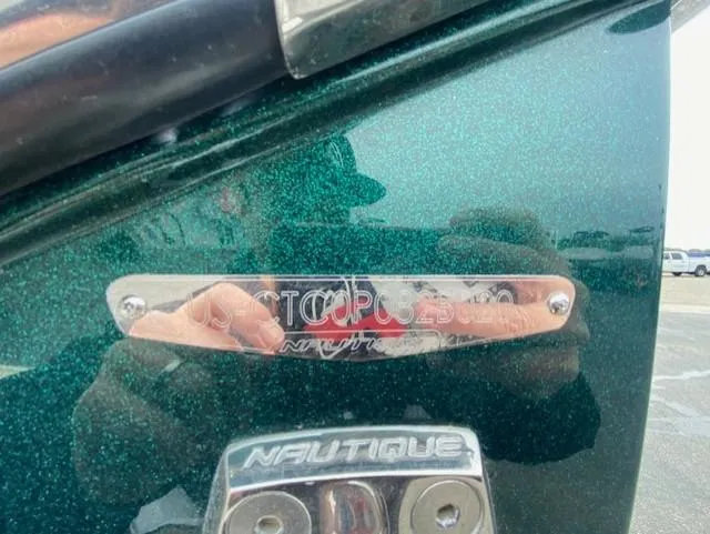 Slide: The Image of 2020 Nautique PARAGON 23 boat with metallic green finish and Nautique branding. - 19