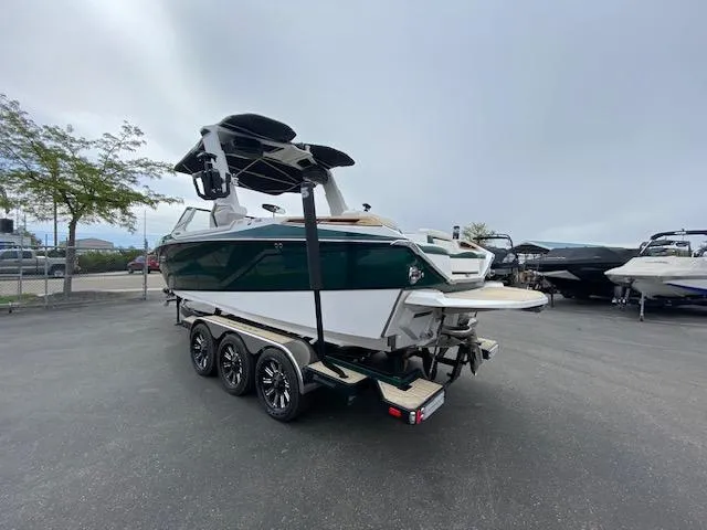 Slide: The Image of 2020 Nautique PARAGON 23 boat on a trailer in a parking lot. - 5