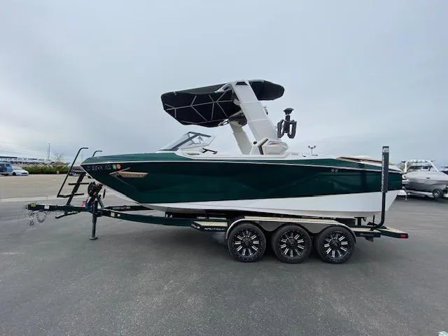Slide: The Image of 2020 Nautique PARAGON 23 boat on a trailer, side view, with a canopy. - 6