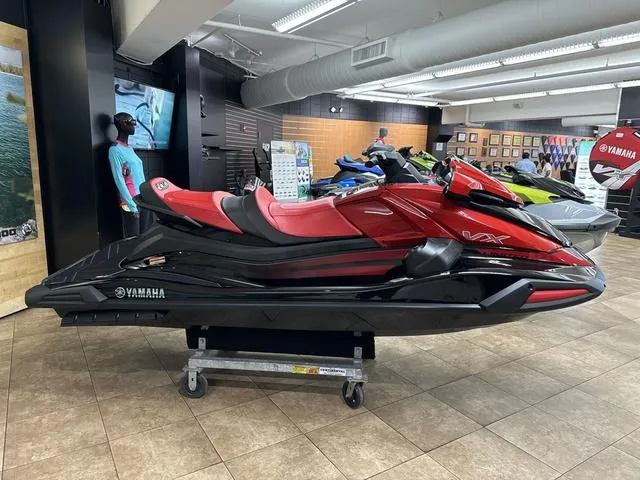 Slide: The Image of 2024 Yamaha WaveRunner VX Limited in showroom, red and black design. - 3