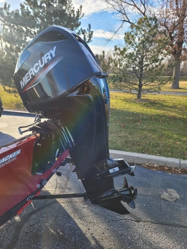 Slide: The Image of 2024 Tracker Bass Tracker Classic XL with Mercury outboard motor in a park. - 2