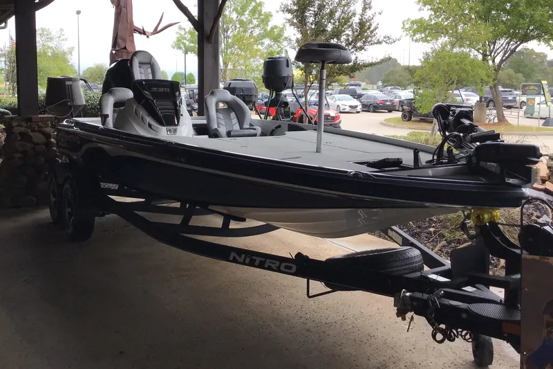 The Image of 2024 Nitro Z20 Pro fishing boat on trailer, parked under shelter. - 0