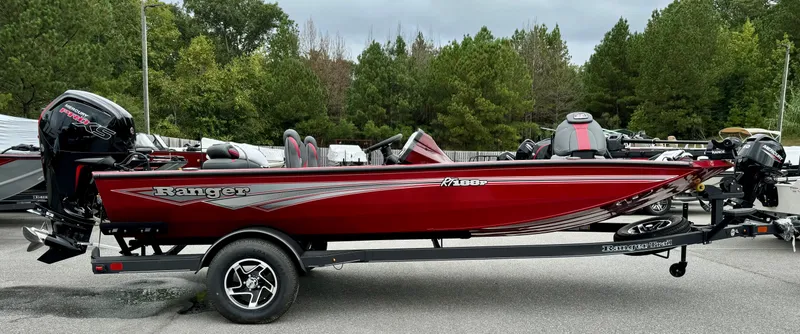 Slide: The Image of 2024 Ranger RT188P fishing boat on trailer, side view, parked on road. - 0