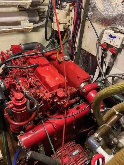 Slide: The Image of Red engine in a 1975 Allied Mistress boat, surrounded by cables and hoses. - 6