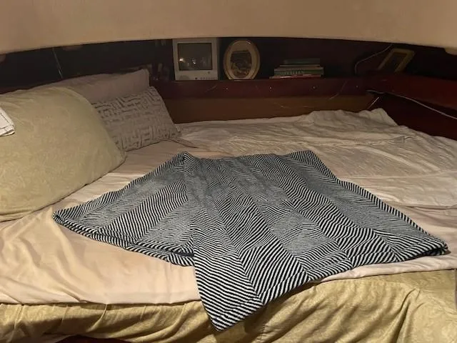 Slide: The Image of Cozy bed in 1975 Allied Mistress boat cabin with striped blanket and pillows. - 7