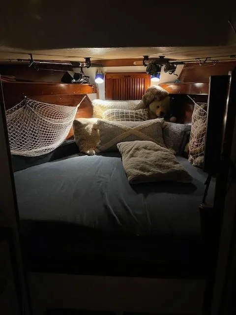 Slide: The Image of Cozy 1975 Allied Mistress boat cabin with pillows, nets, and soft lighting. - 8