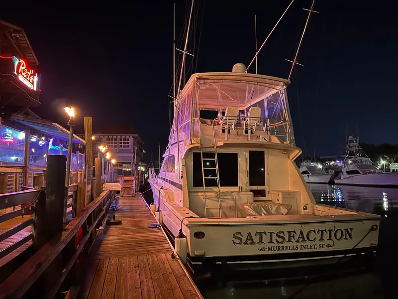 Slide: The Image of 1999 Bertram 60 Convertible yacht docked at night in Murrells Inlet, SC. - 10
