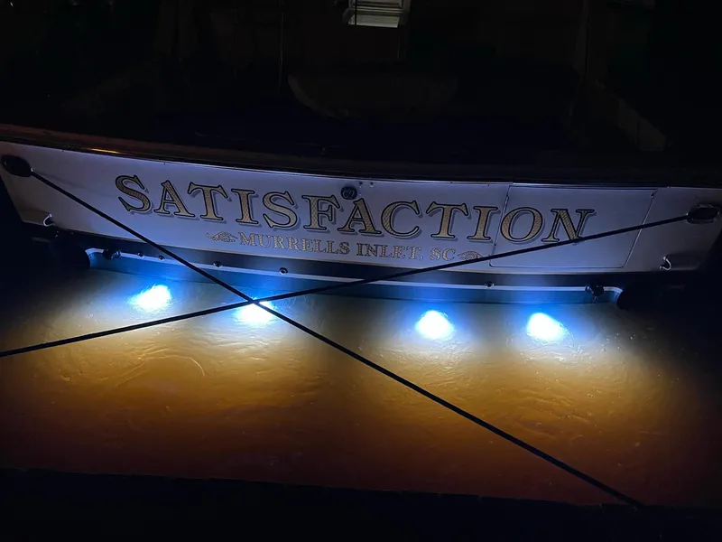 Slide: The Image of 1999 Bertram 60 Convertible boat Satisfaction with underwater lights at night. - 11