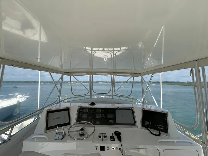 Slide: The Image of Cockpit view of a 1999 Bertram 60 Convertible yacht with Garmin navigation systems. - 21