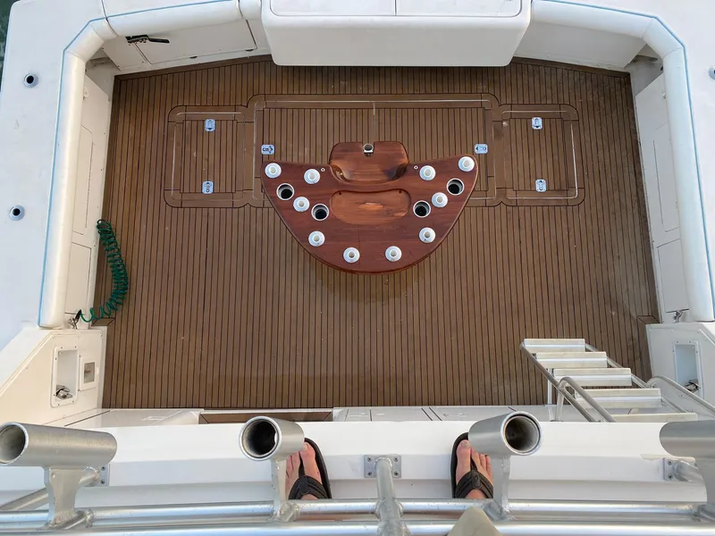 Slide: The Image of Bertram 60 Convertible 1999 fishing deck with rod holders and teak flooring. - 31