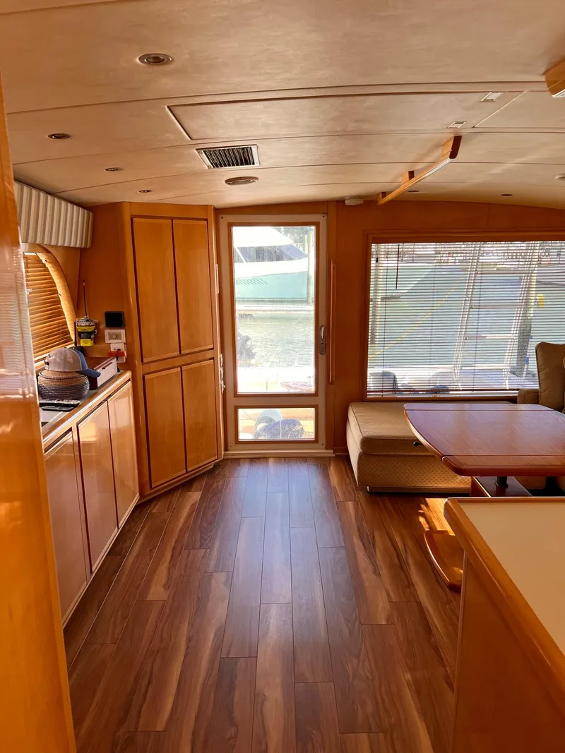Slide: The Image of Interior of a 1999 Bertram 60 Convertible yacht with wooden flooring and cabinetry. - 34