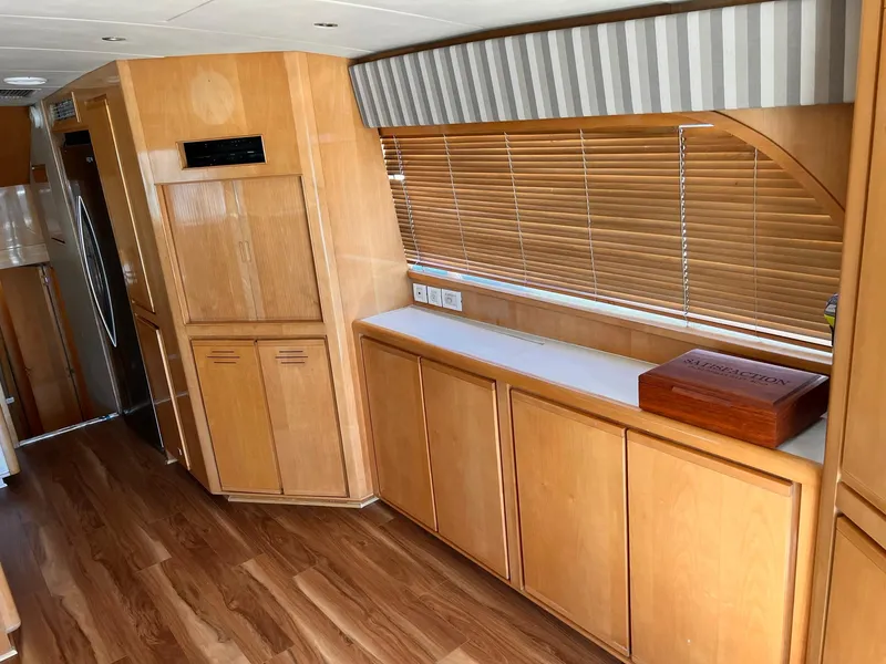 Slide: The Image of Interior of 1999 Bertram 60 Convertible yacht with wooden cabinets and blinds. - 37