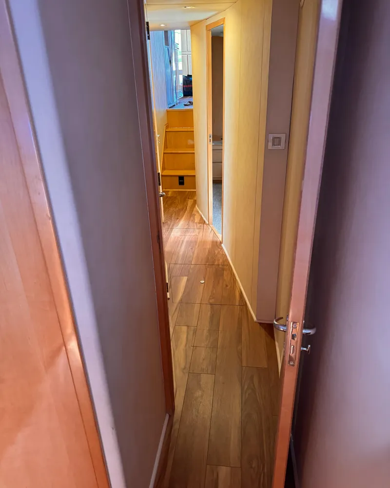 Slide: The Image of Interior hallway of 1999 Bertram 60 Convertible yacht with wooden flooring. - 43