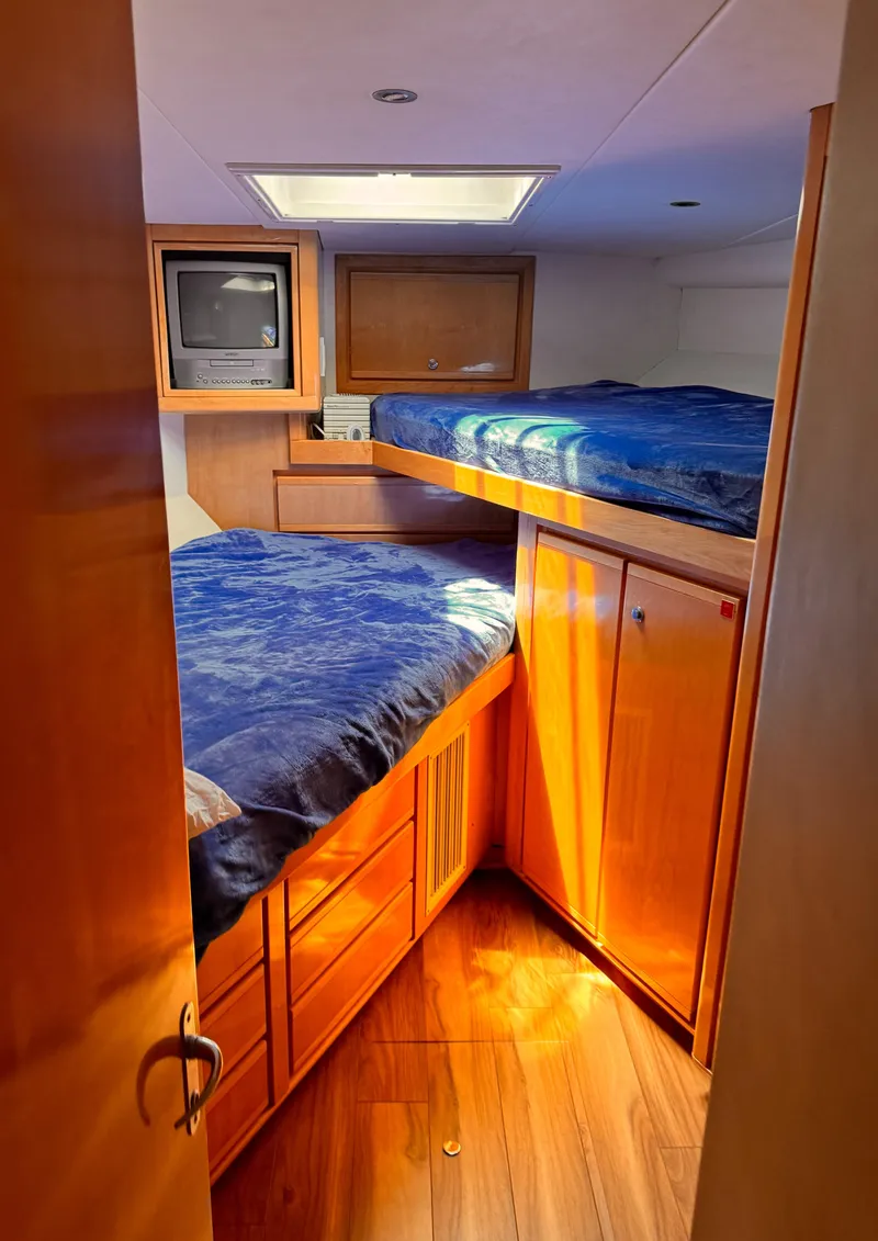 Slide: The Image of Cozy cabin interior of a 1999 Bertram 60 Convertible yacht with wooden furnishings. - 45